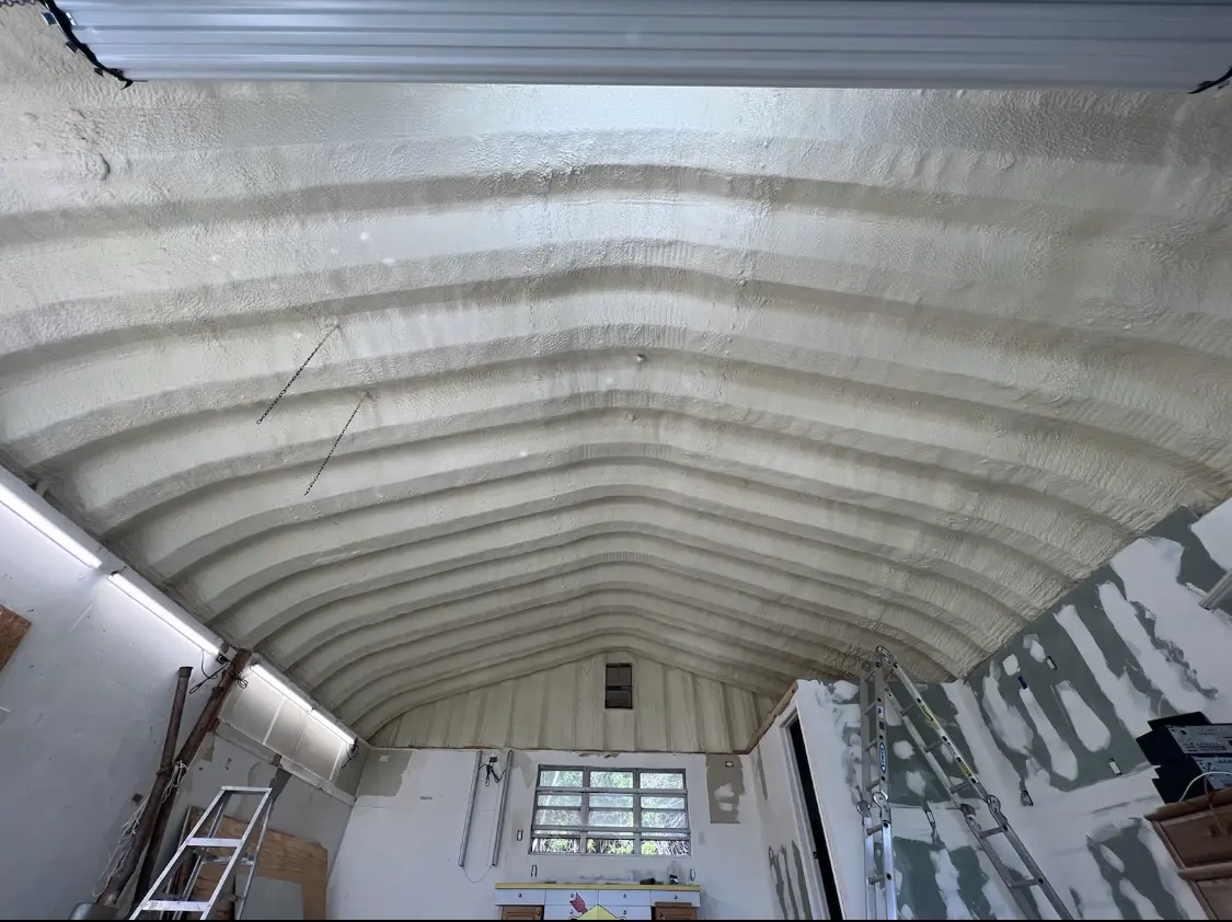 Spray polyurethane foam applied to the underside of a metal roof deck in Donna